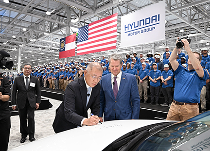 In Savannah, Hyundai Motor Group Metaplant America's (HMGMA) Grand Opening included a grand announcement. Hyundai Motor Company President and CEO José Muñoz shared the automaker will also increase production from 300,000 to 500,000 units a year on the site. Pictured here, Euisun Chung, Executive Chair of Hyundai Motor Group, signs off on a vehicle as Georgia Gov. Brian Kemp looks on.